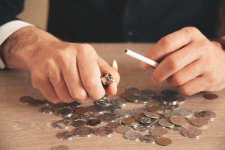 businessman hand holding coins putting in jar concept finance and accounting savingの写真素材