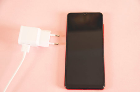 smart phone with usb on pink desk