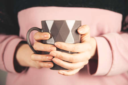 woman hand holding cup of tea or coffeeの写真素材
