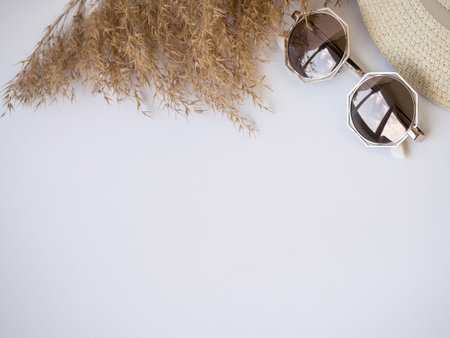 sunglasses, straw hat and dry grass top view izolated copy paste space.の写真素材