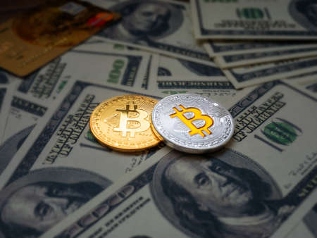 Bitcoins, New Virtual money concept.Gold bitcoins with credit card and dollars' background. Golden coins with icon letter B. Mining or blockchain technology.の写真素材