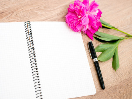 Pink floral assorted pink flower on wooden background with notepad free space, copy space for tekst,