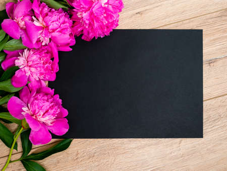 Pink floral assorted pink flower on wooden background with black paper free space, copy space for tekst.の写真素材