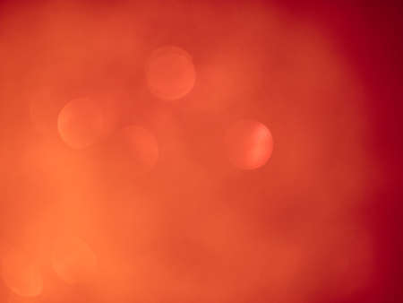 Blurred background lights. Abstract defocused gold, white, red and yellow glitters texture. Shining glowing effects.の写真素材