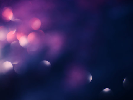 Blurred background lights. Abstract defocused gold, white, red and yellow glitters texture on black...