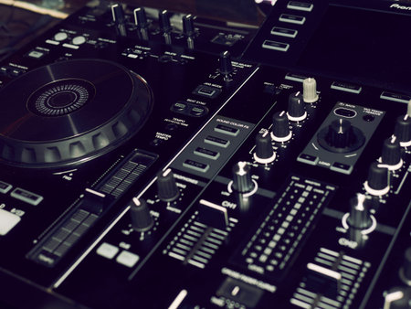 Sound mixing console detail, close up. DJ professional music console. Wide angle photo of black...