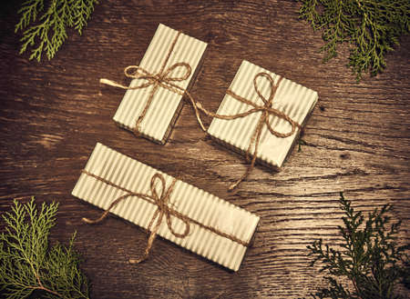 Christmas composition. Christmas gifts, pine branches, toys on wood background. Flat lay, top viewの写真素材