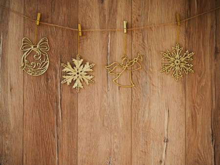 Christmas decorations on a wooden background. New Year decorations and free space for text on a wooden background. Holidays decor on the clothespins. Vintage texture.の写真素材