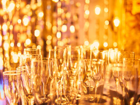 New years eve celebration background with glasses of champagne. Vintage gold Fireworks and bokeh in New Year eve and copy space. Abstract background holidayの写真素材