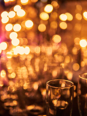 New years eve celebration background with glasses of champagne. Vintage gold Fireworks and bokeh in New Year eve and copy space. Abstract background holiday.の写真素材