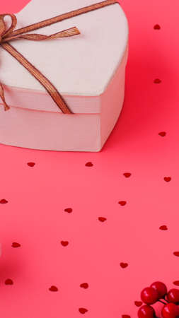 St. Valentine day background. Gift box with gold ribbon and lights on a pink background. Holiday background.の写真素材