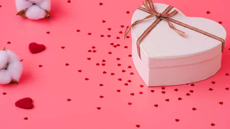 St. Valentine day background. Gift box with gold ribbon and lights on a pink background. Holiday backgroundの写真素材