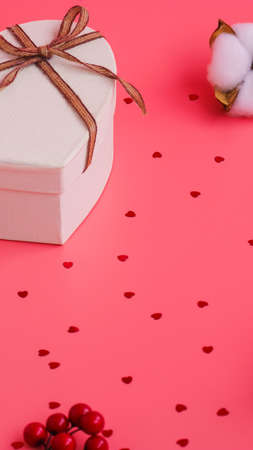 St. Valentine day background. Gift box with gold ribbon and lights on a pink background. Holiday backgroundの写真素材