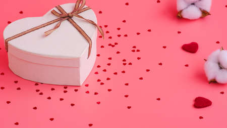St. Valentine day background. Gift box with gold ribbon and lights on a pink background. Holiday backgroundの写真素材