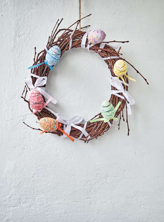 Easter composition on wooden background, Easter background with Easter eggs in nest and spring flowers. Top view with copy space.の写真素材