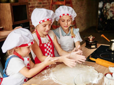 Young girls making cakes. Family cooking. Spend family time togetherの写真素材