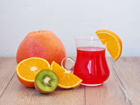 Grapefruit juice with ripe grapefruit and orange on a wooden background.の写真素材
