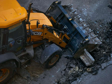 Buldozer Making and constructing a new asphalt road near the civil building. Concepts of improvement of the territory of buildings.のeditorial素材