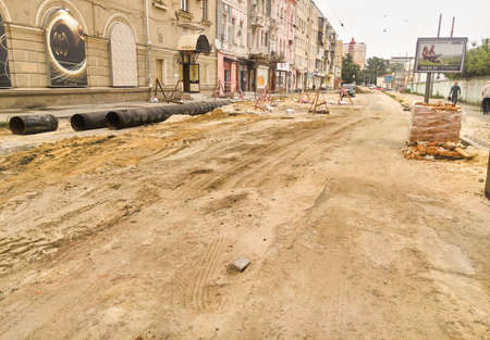 KHARKOV, UKRAINE - MAY 2020, Road modernization, laying or replacement of old pipes. Repair work of water main. Department of housing and communal servicesの写真素材