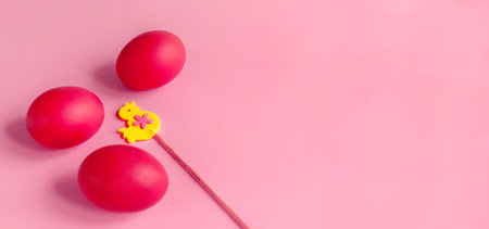 Easter card with painted eggs and little chicken made of felt on a stick. copyspace.の写真素材