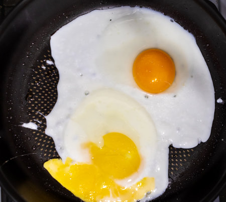 fried eggs in a frying panの写真素材