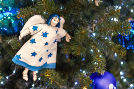 handmade Christmas angel on holiday tree. Copy spaceの写真素材