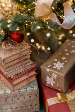 Gifts and books under Christmas tree. Boxing Day. vertically.の写真素材