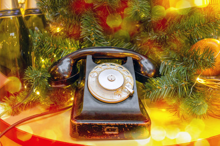 Vintage retro telephone with disk and handset under Christmas tree.の写真素材