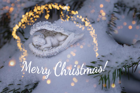 Christmas card with sleeping baby angel on snowy fir tree branch. Merry Christmas.の写真素材