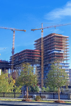 Construction site with cranes and unfinished buildings.