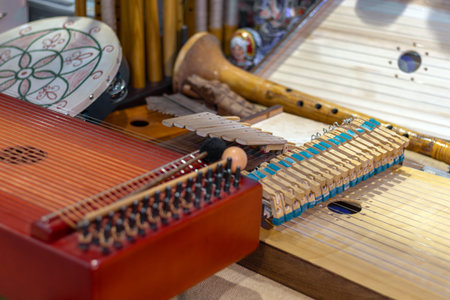Assortment of traditional antique musical instruments displayed together, includes string,...