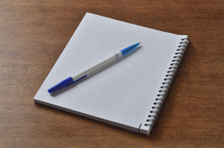 Notebook on the desk with a pen for writingの写真素材