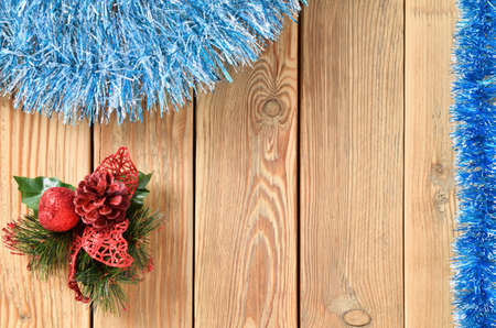 New year theme for postcards. Decorations for Christmas decorations. Wooden background with Christmas toys. Festive garland on a wooden background. Festive mood. Copy space for text.の写真素材