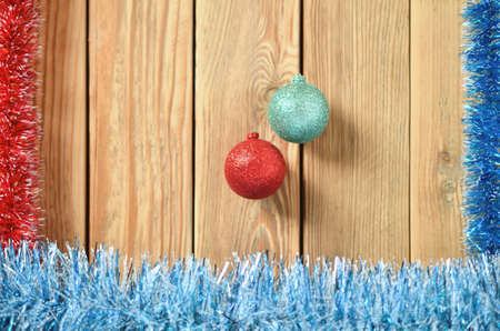 New year theme for postcards. Decorations for Christmas decorations. Wooden background with Christmas toys. Festive garland on a wooden background. Festive mood. Copy space for text.の写真素材