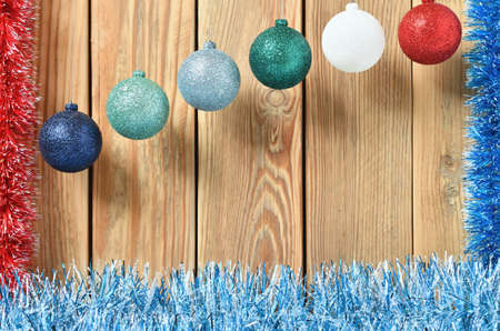 New year theme for postcards. Decorations for Christmas decorations. Wooden background with Christmas toys. Festive garland on a wooden background. Festive mood. Copy space for text.の写真素材