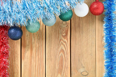 New year theme for postcards. Decorations for Christmas decorations. Wooden background with Christmas toys. Festive garland on a wooden background. Festive mood. Copy space for text.の写真素材