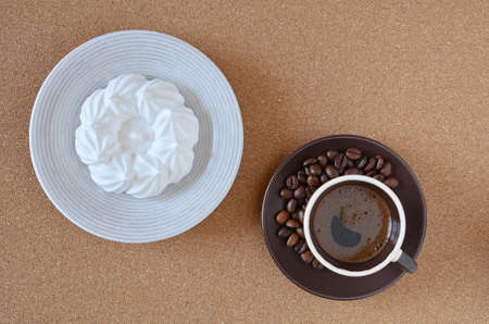 Espresso coffee and fresh meringue on top of the cork napkin.の写真素材