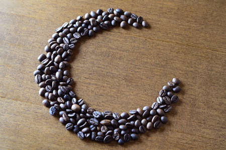 Coffee beans on a wooden table. roasted coffee beans on a wooden background.の写真素材
