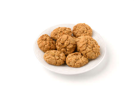 Oatmeal cookies on a white plate isolated on a white background.の写真素材