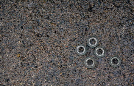 Five nuts. Wet asphalt