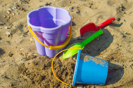 Baby buckets and paddles lie on the sandの写真素材