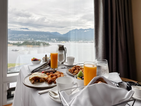 Breakfast on the table with a view of the ocean and mountains. Vancouver, Canada.の写真素材