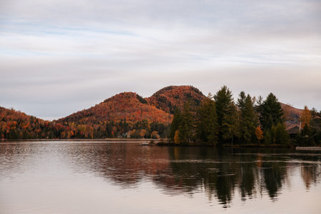 A picturesque autumn landscape featuring a lake surrounded by mountains. Quebec, Canada.の写真素材