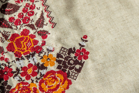 Ukrainian clothes embroidered shirt. Red orange and black threads background. Vyshyvanka is a symbol of Ukraine. Embroidery cross stitching. National Ukrainian stitch. Traditional clothing symbolの写真素材