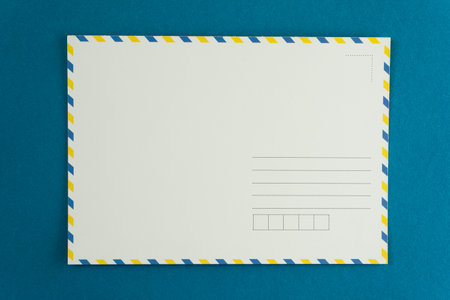 Blank postcard of an open letter. Mail background. Postcrossing layout place for text top view. Postal background. Stamp delivery envelope. Mockup copy space.の写真素材