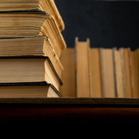 Collection of old books on wooden background. Book in the library. Bookshelf shop. Knowledge...