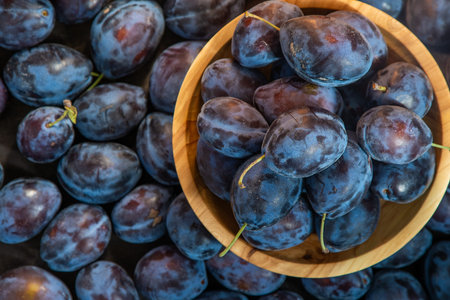 Plum variety Hungarian. Fruit harvest on the table in the kitchen. Autumn blue plum. Vitamin food...