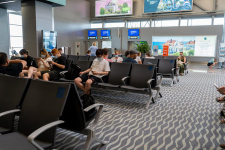 Ukraine, Odessa - July 16, 2021: Odessa airport. Inside the terminal before the flight. Odesa ODS Airport. Masked people are waiting to board the plane. Travelers at the airport in the waiting roomのeditorial素材