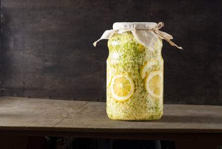 Elder flowers drink juice glass. White flower and lemon. Harvesting buds for making syrup and drink...