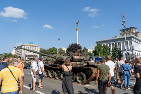 Exhibition of burnt Russian military equipment on Khreschatyk. Tank, armored personnel carrier and Ukrainian people on the street during the war with Russia. Ukraine, Kyiv - August 21, 2022.のeditorial素材